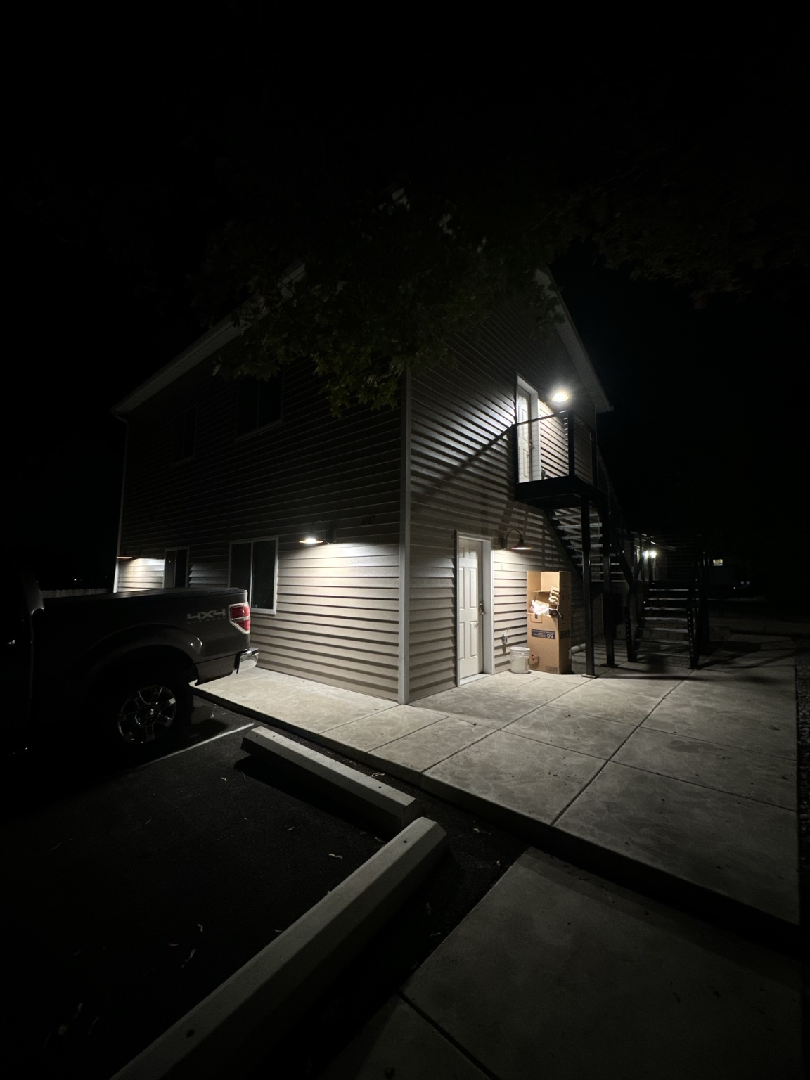 Building exterior at night lit by wall-mounted lights